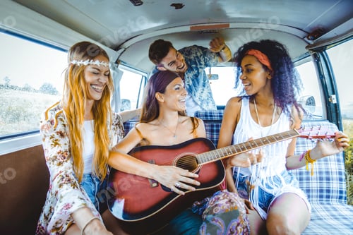 Preview: Happy friends driving a vintage minivan