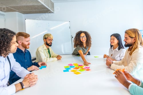 Preview: Woman reading adhesive notes during a brainstorming in a meeting
