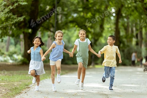 Preview: Group of asian and caucasian kids having fun in the park