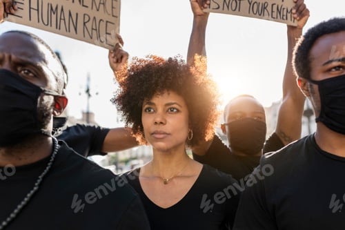 Preview: Crop black protesters with placards on strike in town