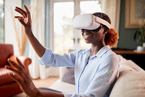 Preview: Woman Relaxing On Sofa At Home Wearing VR Headset And Interacting With AR Technology