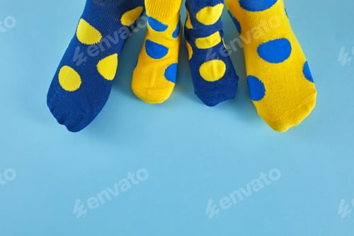 Preview: World Down syndrome day background. Legs with different socks as symbol of down syndrome