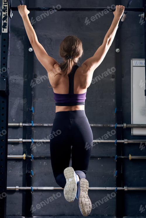 Preview: Muscular Woman Doing Pull Ups in Crossfit Gym