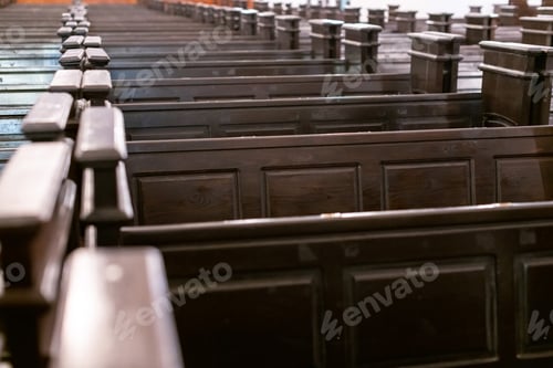 Preview: Cathedral pews. Rows of benches in christian church. Heavy solid uncomfortable wooden seats.