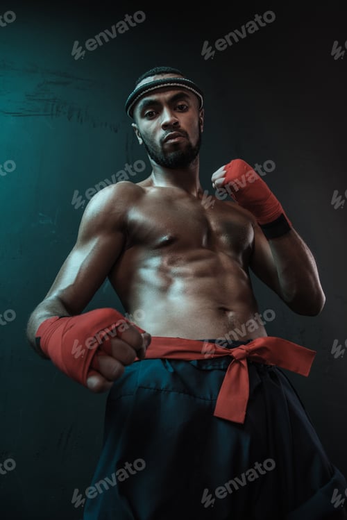 Preview: Muay Thai athlete training at Thai boxing indoors, ultimate fight concept