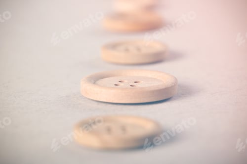 Preview: Wooden Buttons Lie On A Bright Background