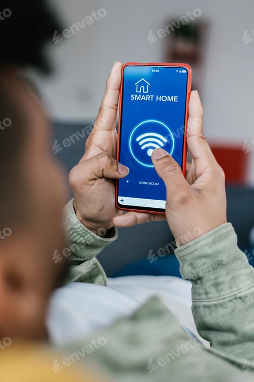Preview: Close-up view of young man connecting smart phone to wifi at home