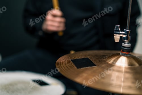 Preview: a young male drummer plays a drum kit in a recording studio at a professional musician's rehearsal r
