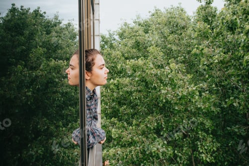 Preview: Woman worried while showing off the window in the city during a spring day, mental health concept