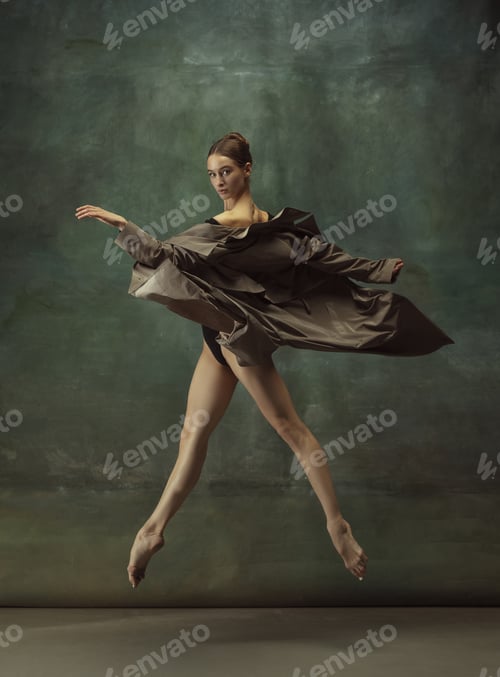 Preview: Young graceful tender ballerina on dark studio background