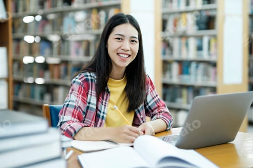 Preview: Portrait of a Smart Beautiful Asian Girl Studing and Reading Text Books Smiling Looking at Camera.