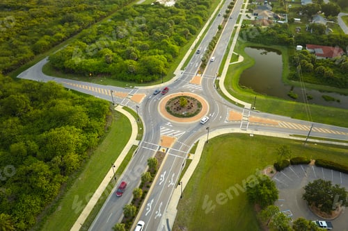 Preview: Aerial view of road roundabout intersection with moving cars traffic.