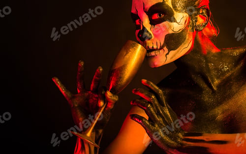 Preview: Pretty girl with skeleton makeup holds glass
