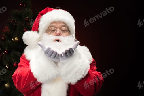 Preview: Portrait of Santa Claus blowing snowflakes from hands