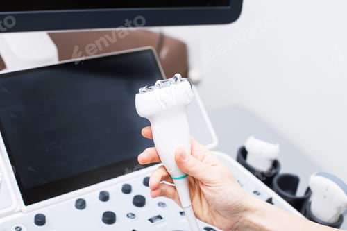 Preview: Woman doctor's hand aholding a medical gel to ultrasonic sensor of ultrasound machine in the clinic