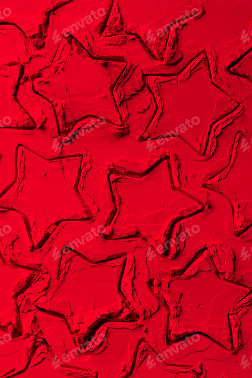 Preview: top view of shapes of cookie cutters in shape of stars on red powder