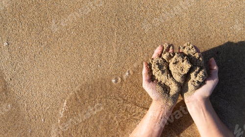 Preview: Sand in palms of women hands, top view