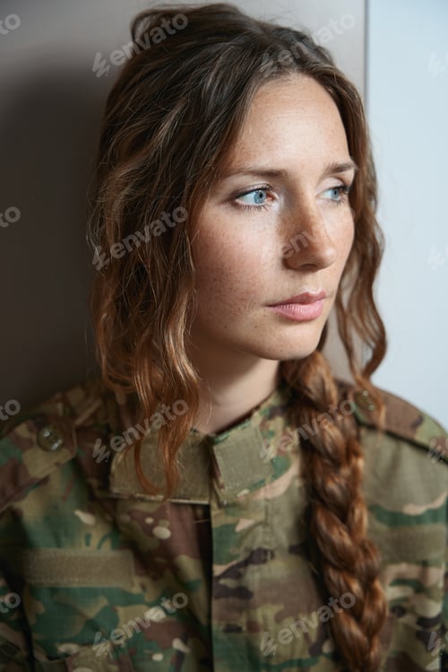 Preview: Woman in camouflage uniform looking to right with serious expression