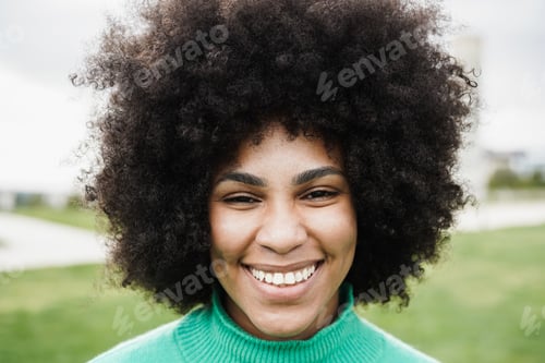 Preview: Happy young african woman smiling on camera outdoor - Focus on face