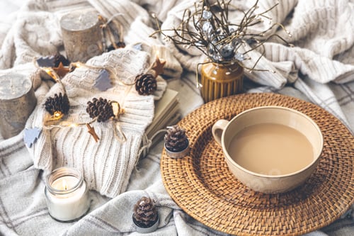 Preview: Cozy autumn composition with a big cup of coffee in bed.