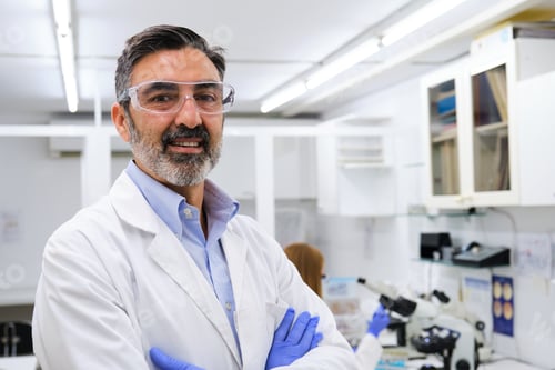 Preview: Middle aged professional researcher smiling and looking at camera.