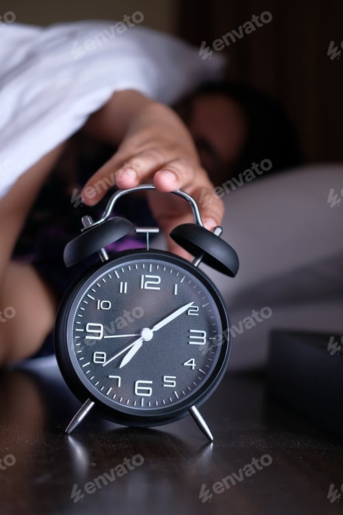 Preview: A person reaches for the alarm clock on their bedside, signaling the start of a new day