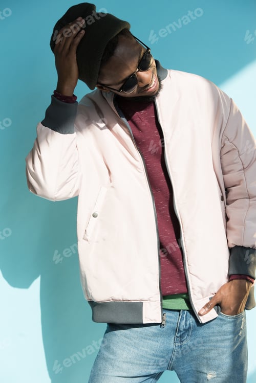Preview: Smiling Man Wearing Beanie and Pink Bomber Jacket