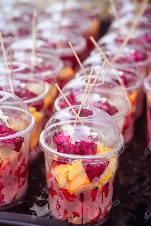 Preview: variety of fresh fruit cuts in a container.