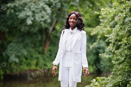 Preview: Stylish black african american girl posing on park background river