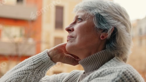 Preview: Contemplative Elder Woman Outdoors In Cozy Sweater