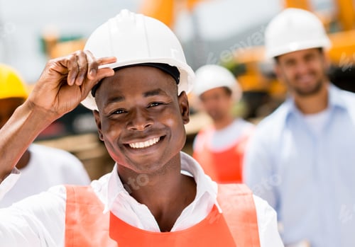 Preview: Happy Construction Worker At A Building Site Wearing A Helmet