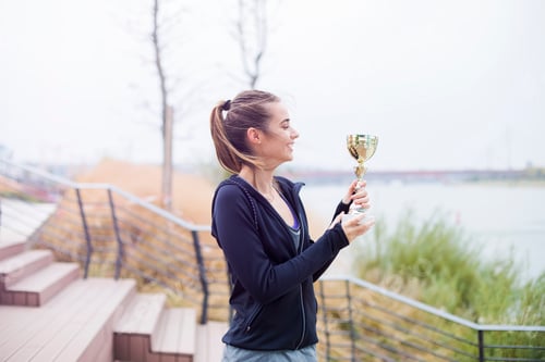 Preview: Sport woman holding a trophy