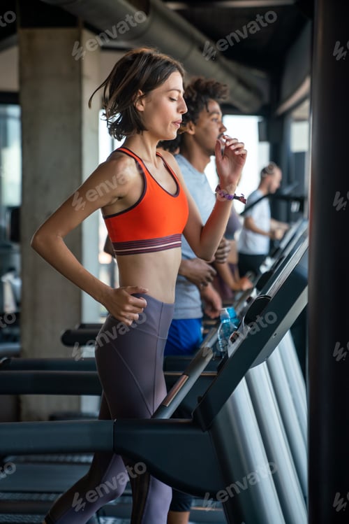 Preview: Young fitness woman exercising in a gym. Sport people health concept