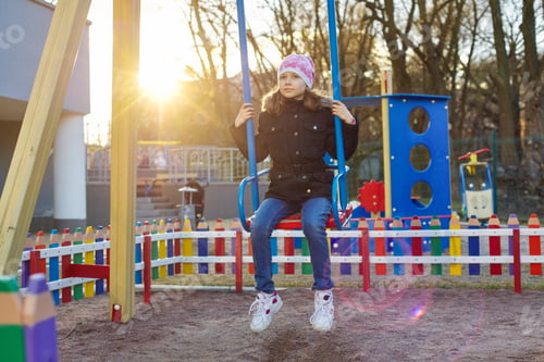 Preview: Girl child 8, 9 years old on swing, childrens playground