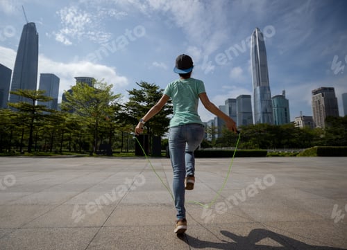 Preview: Fitness woman jumping rope at city
