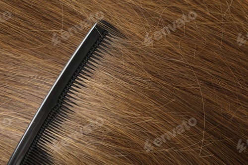 Preview: Comb with beautiful brown hair, closeup view