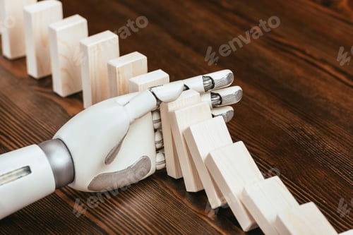 Preview: selective focus of robotic hand preventing wooden blocks from falling on desk