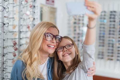 Preview: Joyful Beautiful Woman Making Selfies With Her Nice Daughter While Expressing Gladness