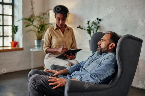 Preview: African female therapist listens to mid adult male client