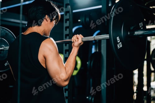 Preview: A determined bodybuilder lifting heavy barbells in the gym
