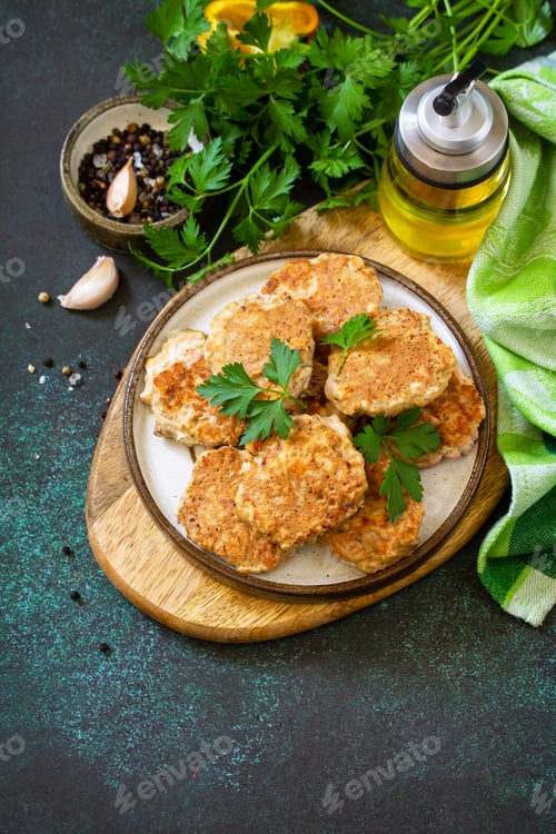 Preview: Red fish cutlets on a dark stone or slate table.