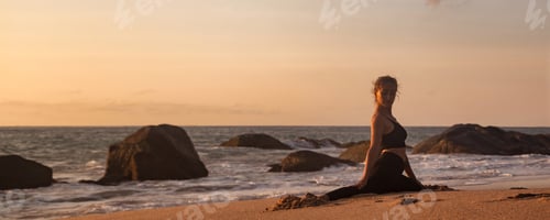 Preview: Young woman does yoga position splits or twine for healthy lifestyle on tropical sea coast beach