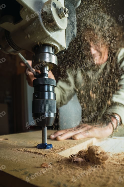 Preview: Woodworker using drilling machine in joinery