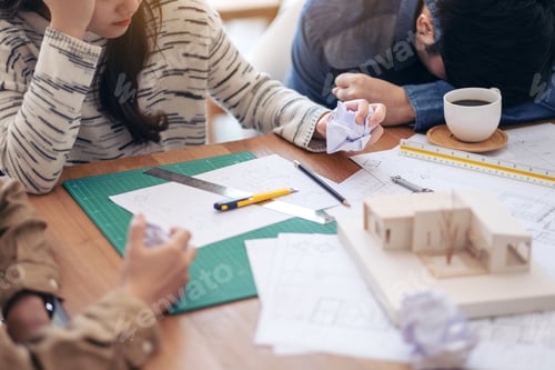 Preview: an architect feel stressed after working on architecture model together with shop drawing paper