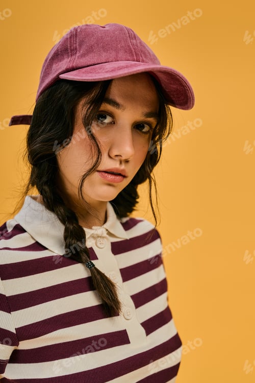 Preview: Young woman in pigtails finds joy in fashion within a bright studio
