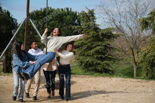 Preview: Friends playing with zip line in a park are having fun