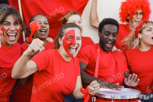 Preview: Multiracial people with red t shirts supporting their soccer team outside of stadium