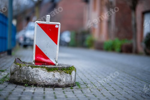 Preview: View of road construction sign with red and white lines on the street