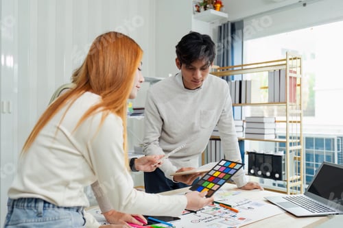 Preview: team of UI UX web designer are working together to develop mobile responsive websites with UI UX