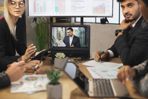 Preview: Group Of Businesspeople Having Video Conference In Boardroom in modern office